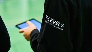 Photograph of a student at The Manchester College wearing a T Levels branded hoodie.